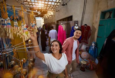 A young couple shopping at a souk in Old Dubai.