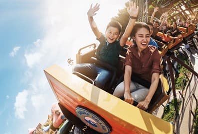 People riding a roller coaster at IMG Worlds of Adventure in Dubai