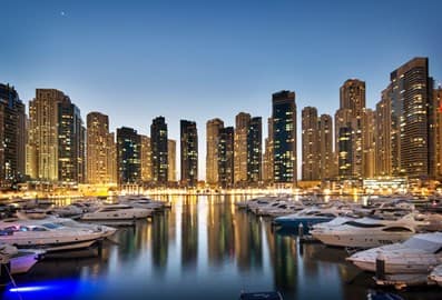 Panoramic view of Dubai Marina with skyscrapers and luxury yachts