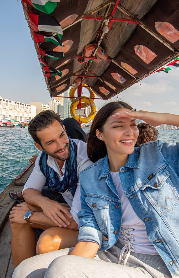 Couple crossing Dubai Creek on an Abra