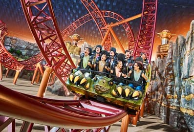 Visitors riding a roller coaster at IMG Worlds of Adventure Dubai