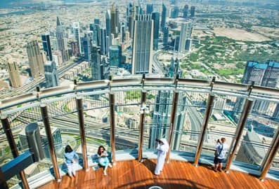 Visitors at Burj Khalifa's observation deck At The Top taking photographs of the city.