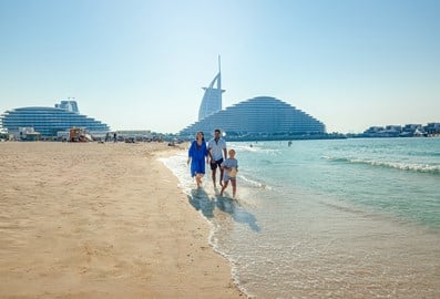 Family on Kite Beach in Dubai with Burj Al Arab and Jumeirah Beach Hotel in the background