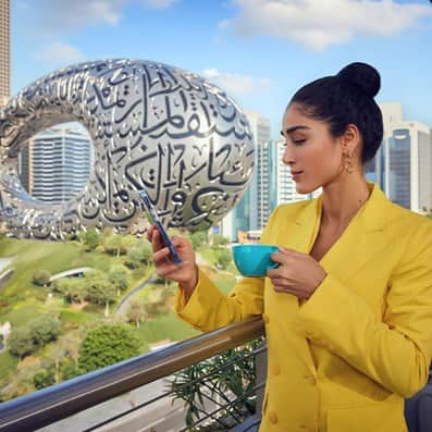 25 Hour Hotel outdoor view of Museum of the future | Female using the mobile