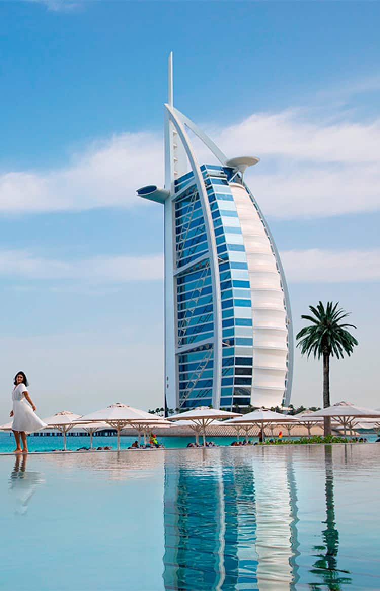 Woman standing infront of Burj Al Arab in Dubai