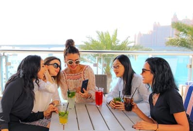 Friends looking at phone Atlantis