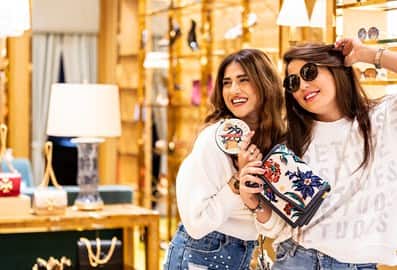 Two girls shopping for handbags in Dubai